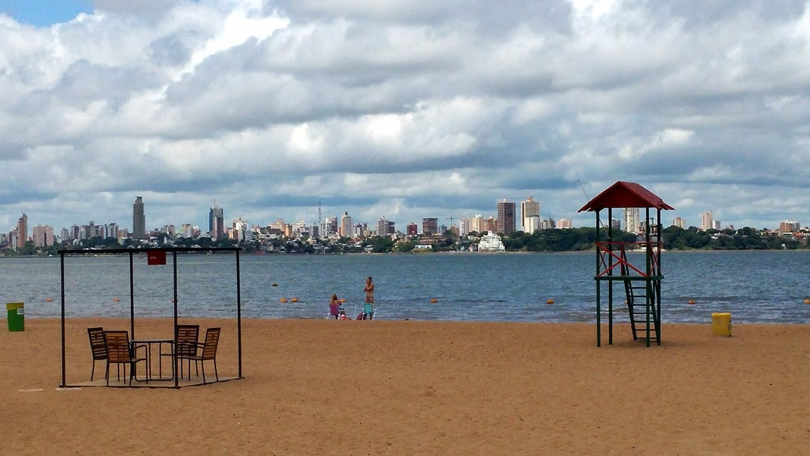 IRONMAN 70.3 Encarnacion: playa san josé beach on the río paraná with encarnación skyline