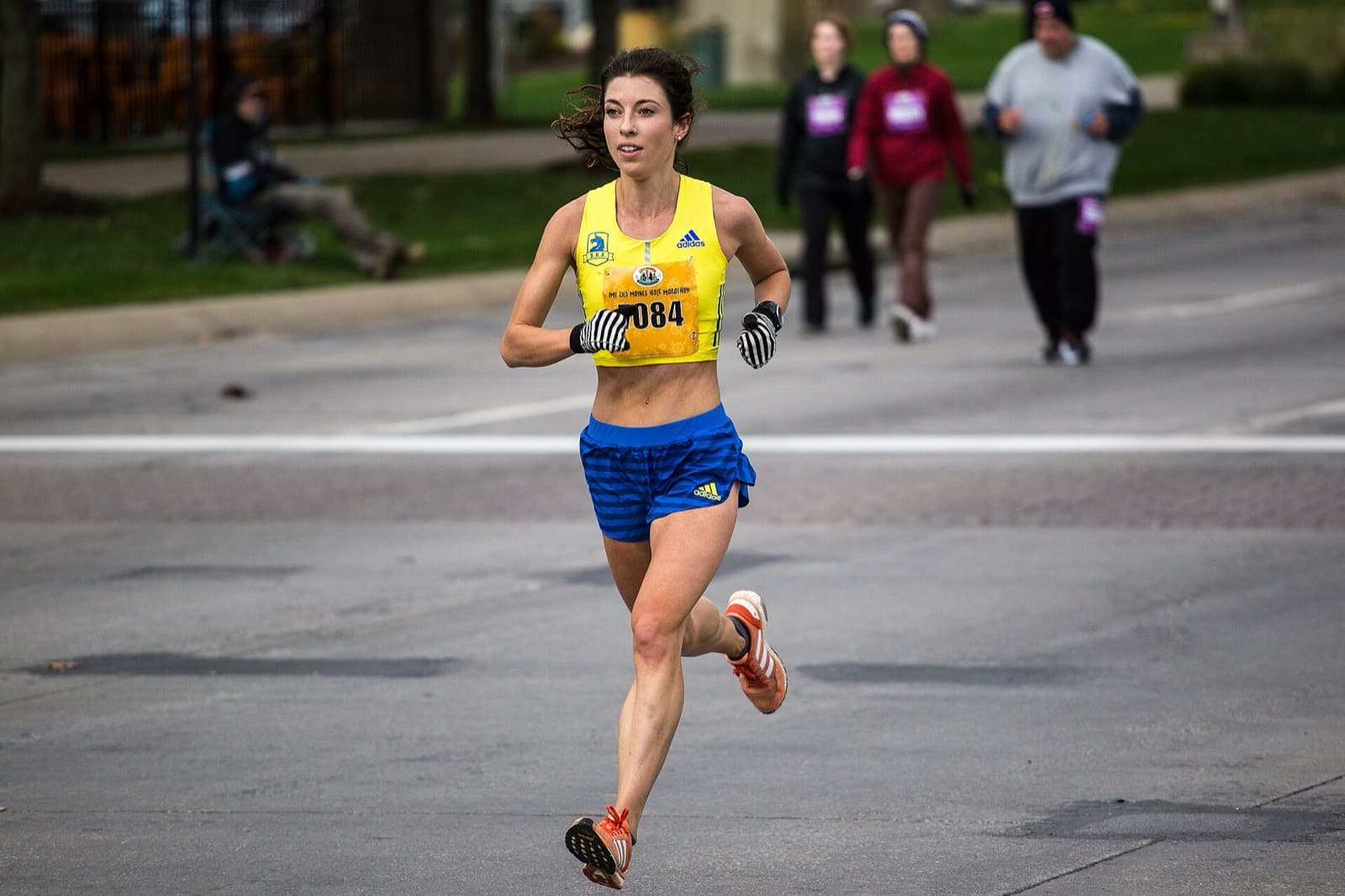 Des Moines Marathon: women's half marathon winner running a downtown street at the 2017 imt des moines races