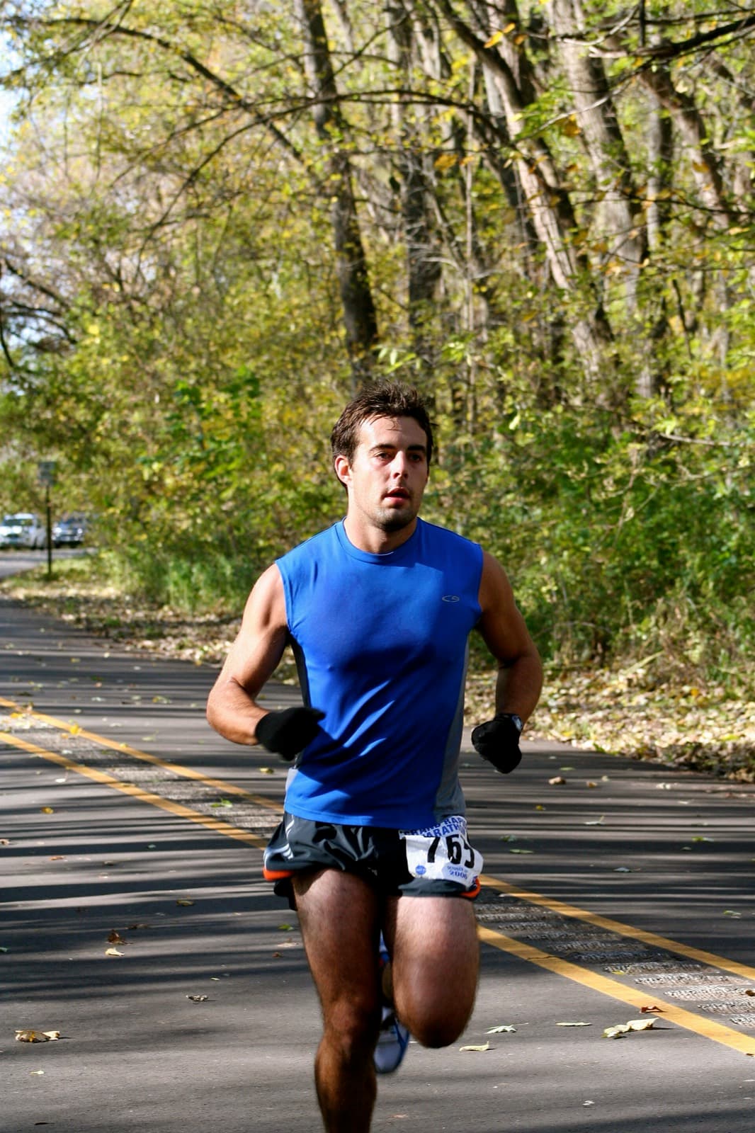 Grand Rapids Marathon: runner on a tree-lined path with fall leaves at the 2006 grand rapids marathon