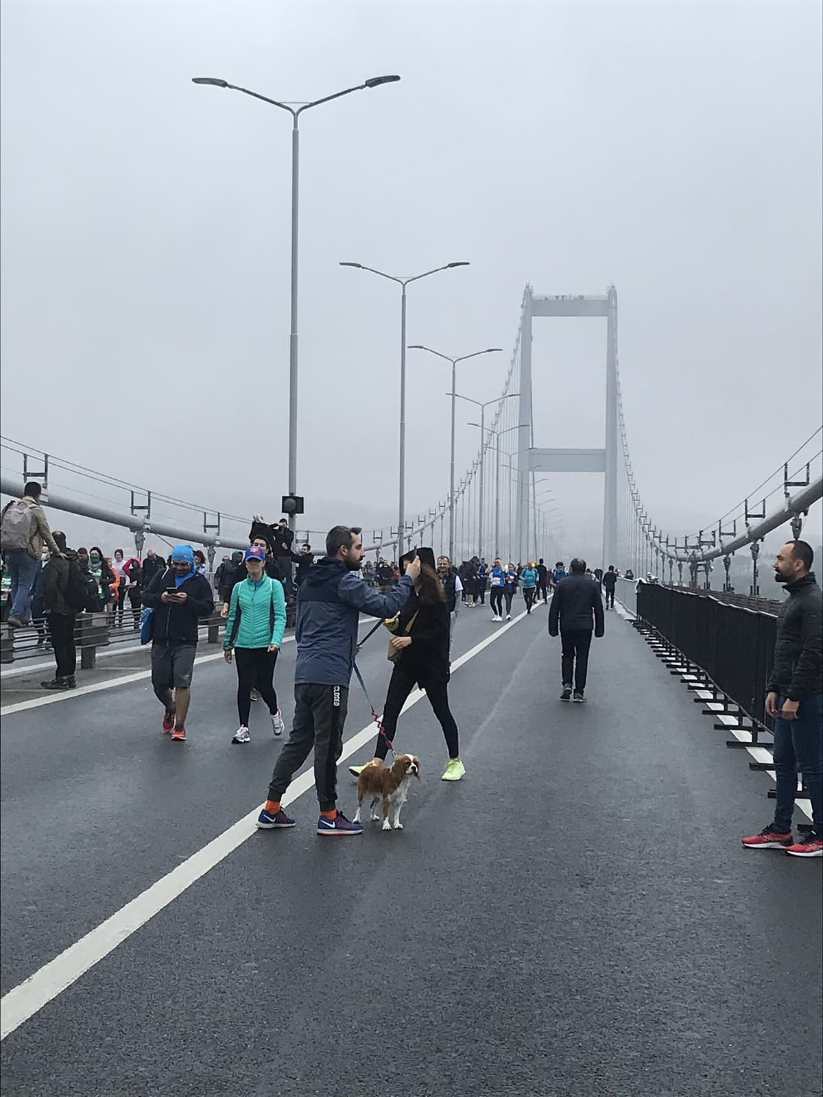 N Kolay Istanbul Marathon: runners and walkers on the bosphorus bridge on marathon day, 7 nov 2021, in fog
