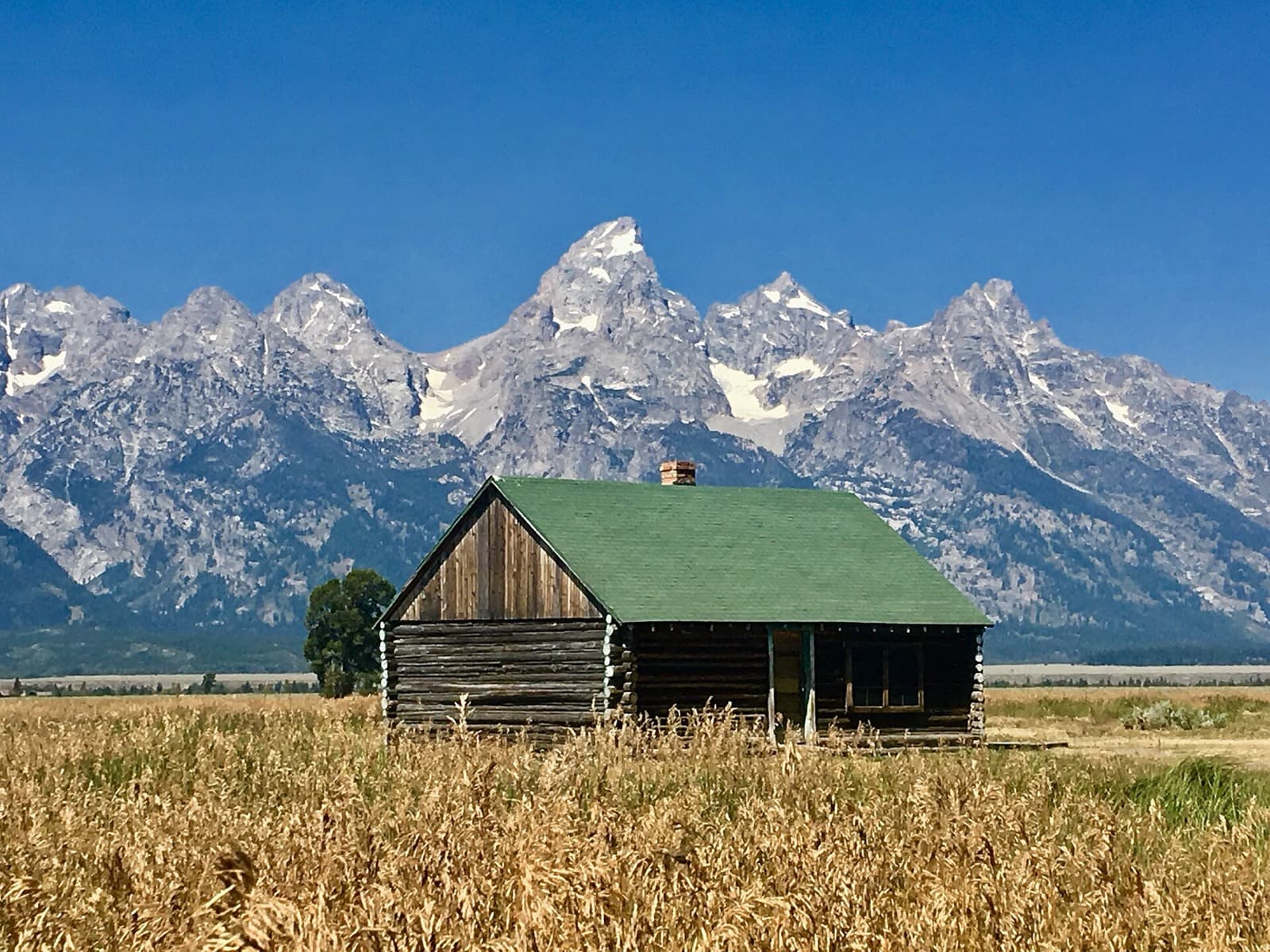 Jackson Hole Marathon: teton range above a historic barn in jackson hole, the valley the course runs through