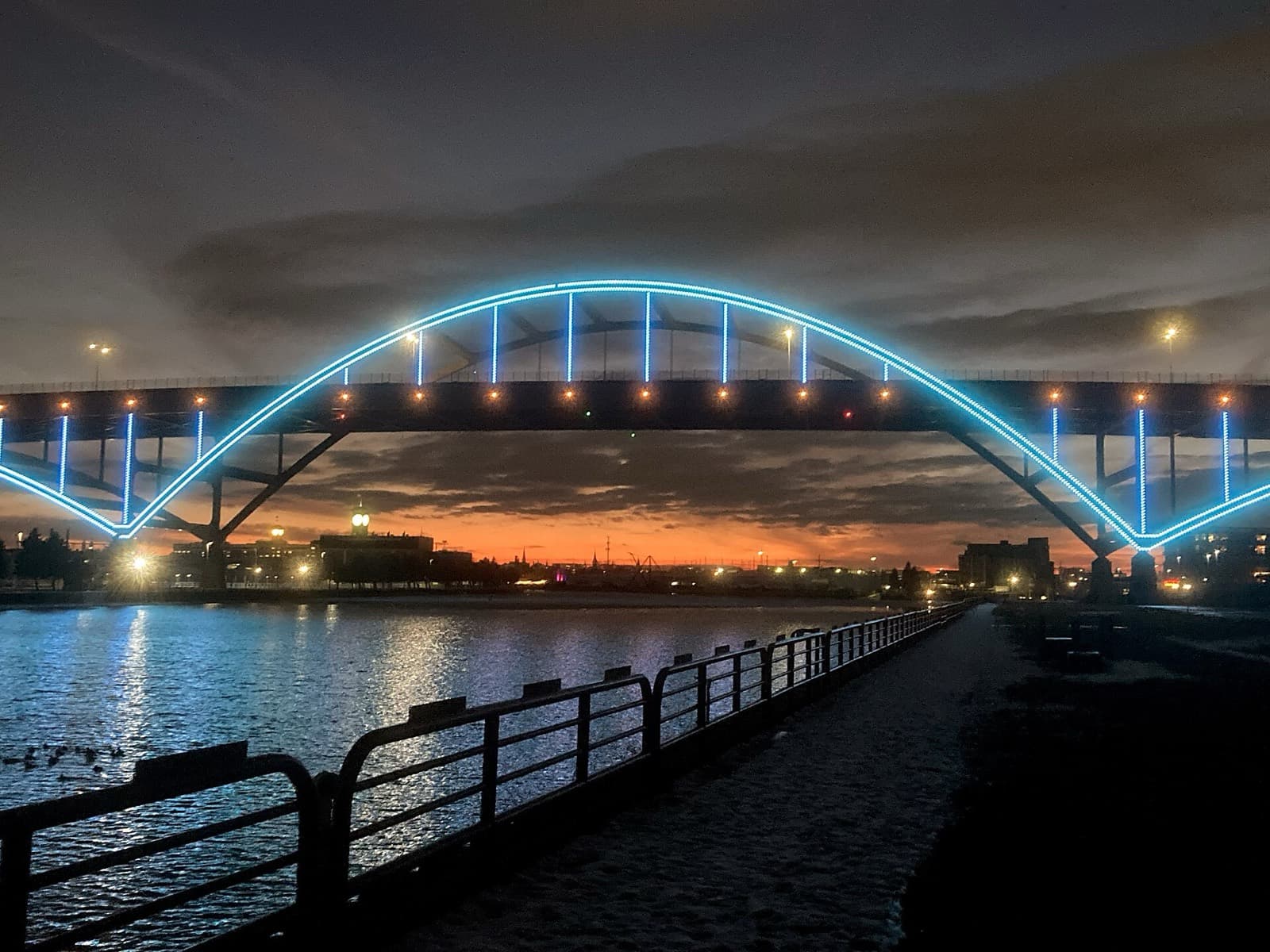 Milwaukee Lakefront Marathon: the hoan bridge in milwaukee, lit at dusk, crossed twice by marathoners