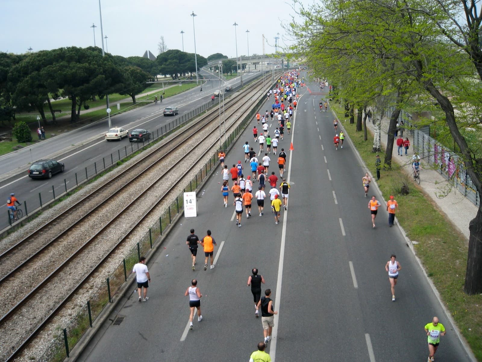 EDP Lisbon Marathon: runners on avenida de brasilia by the tagus during a lisbon marathon