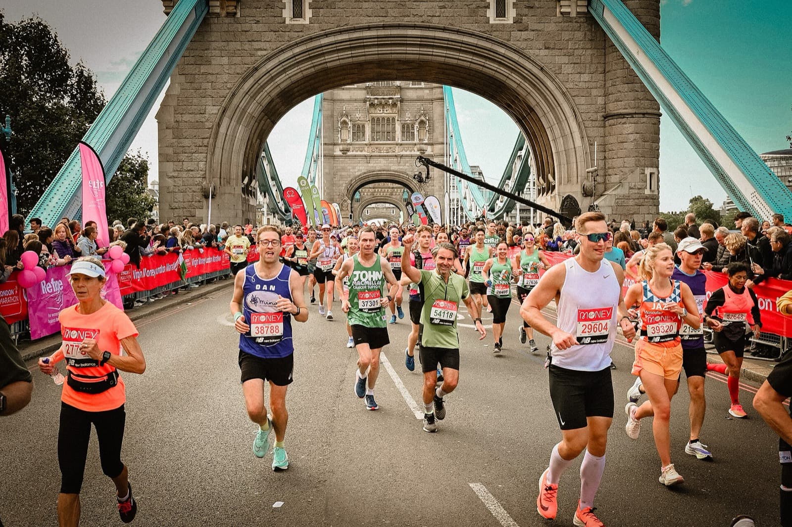 TCS London Marathon: mass runners crossing tower bridge with crowds behind barriers