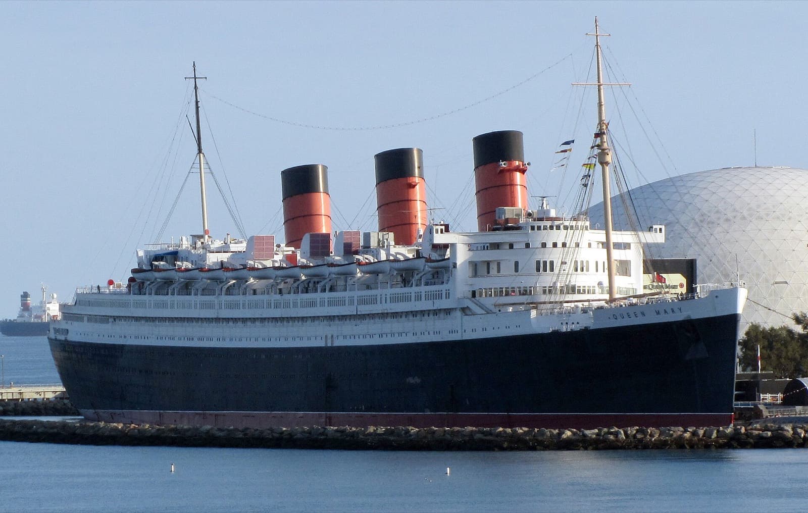 Long Beach Marathon: rms queen mary moored in long beach, passed by marathoners near the start