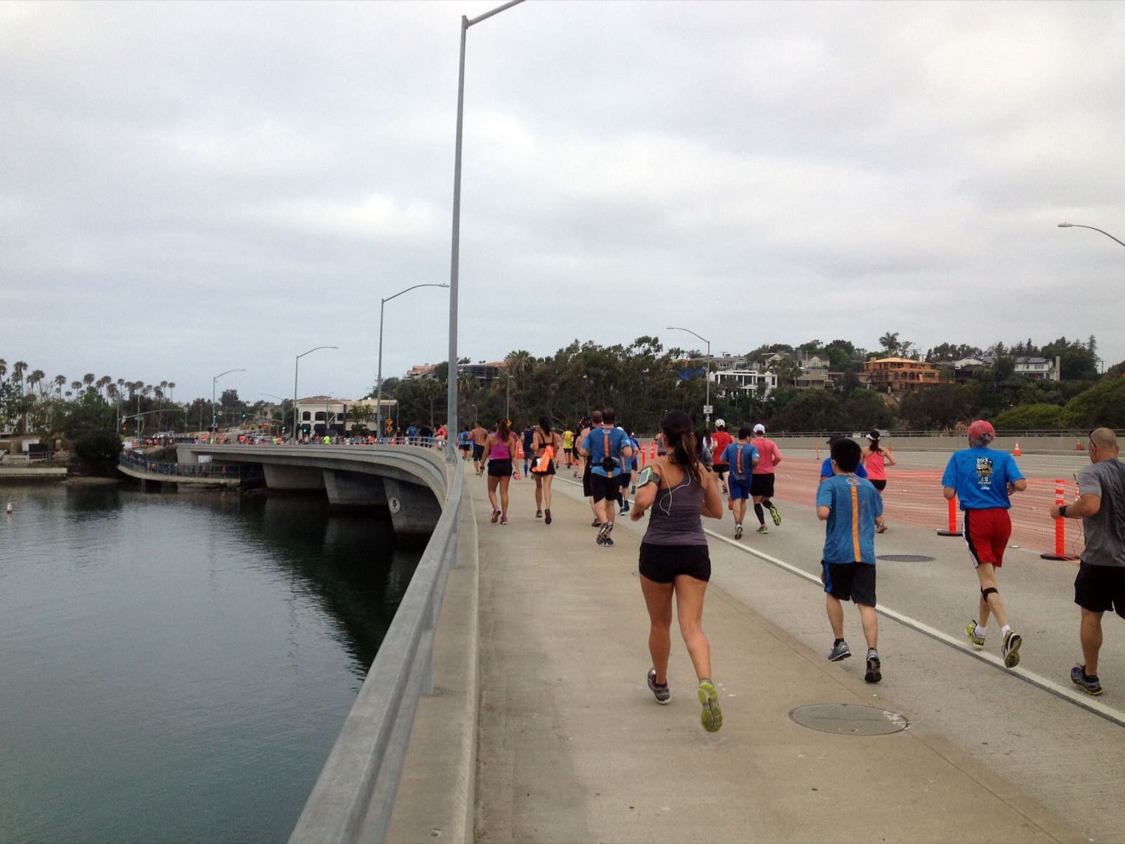 The Hoag OC Marathon Running Festival: runners crossing a bridge over newport bay during the oc marathon