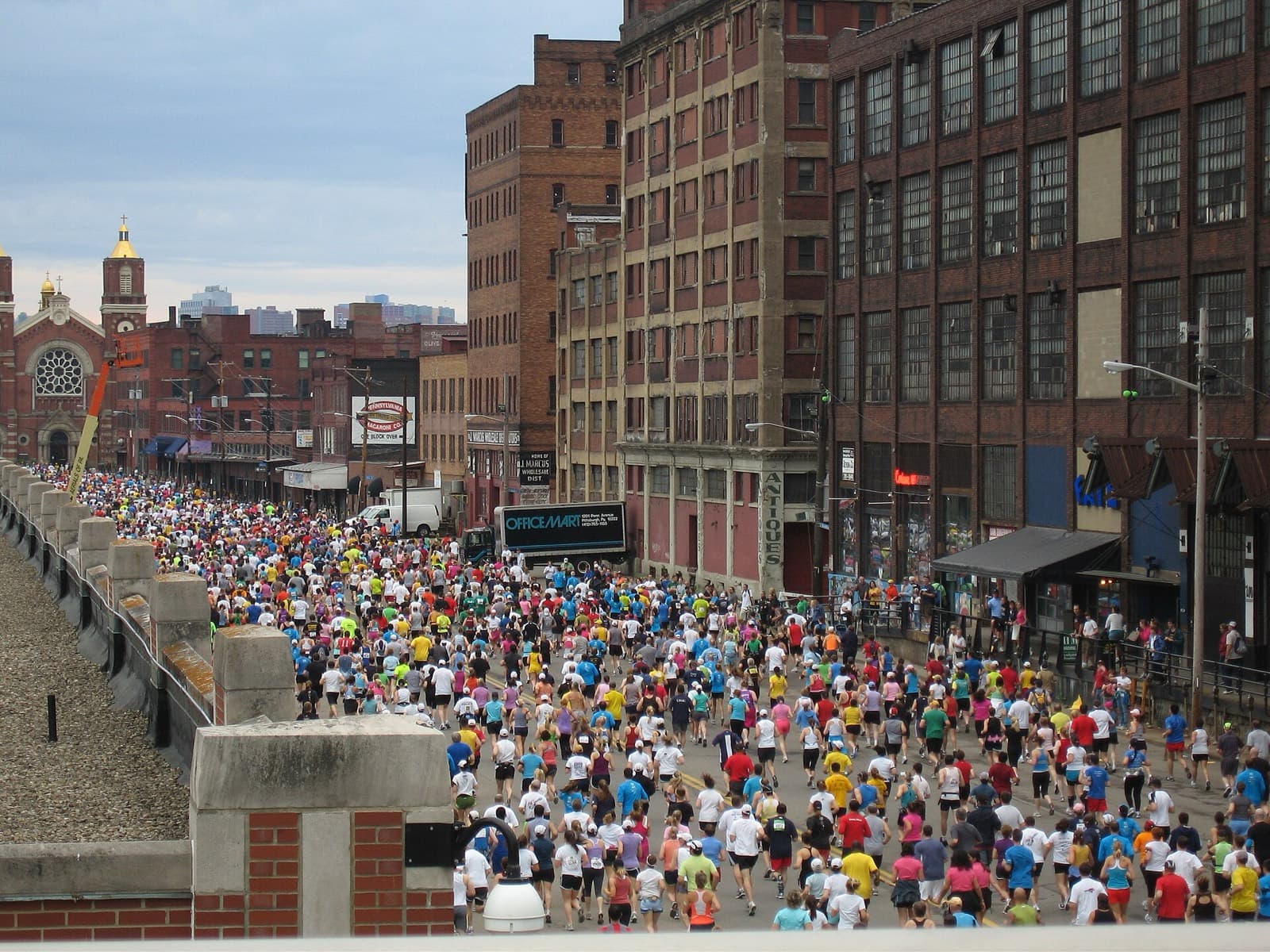UPMC Pittsburgh Marathon: packed field running through brick streets of the strip district