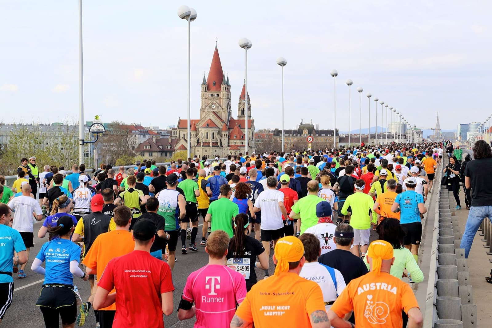 Vienna City Marathon: runners crossing the reichsbrücke toward the franz von assisi church