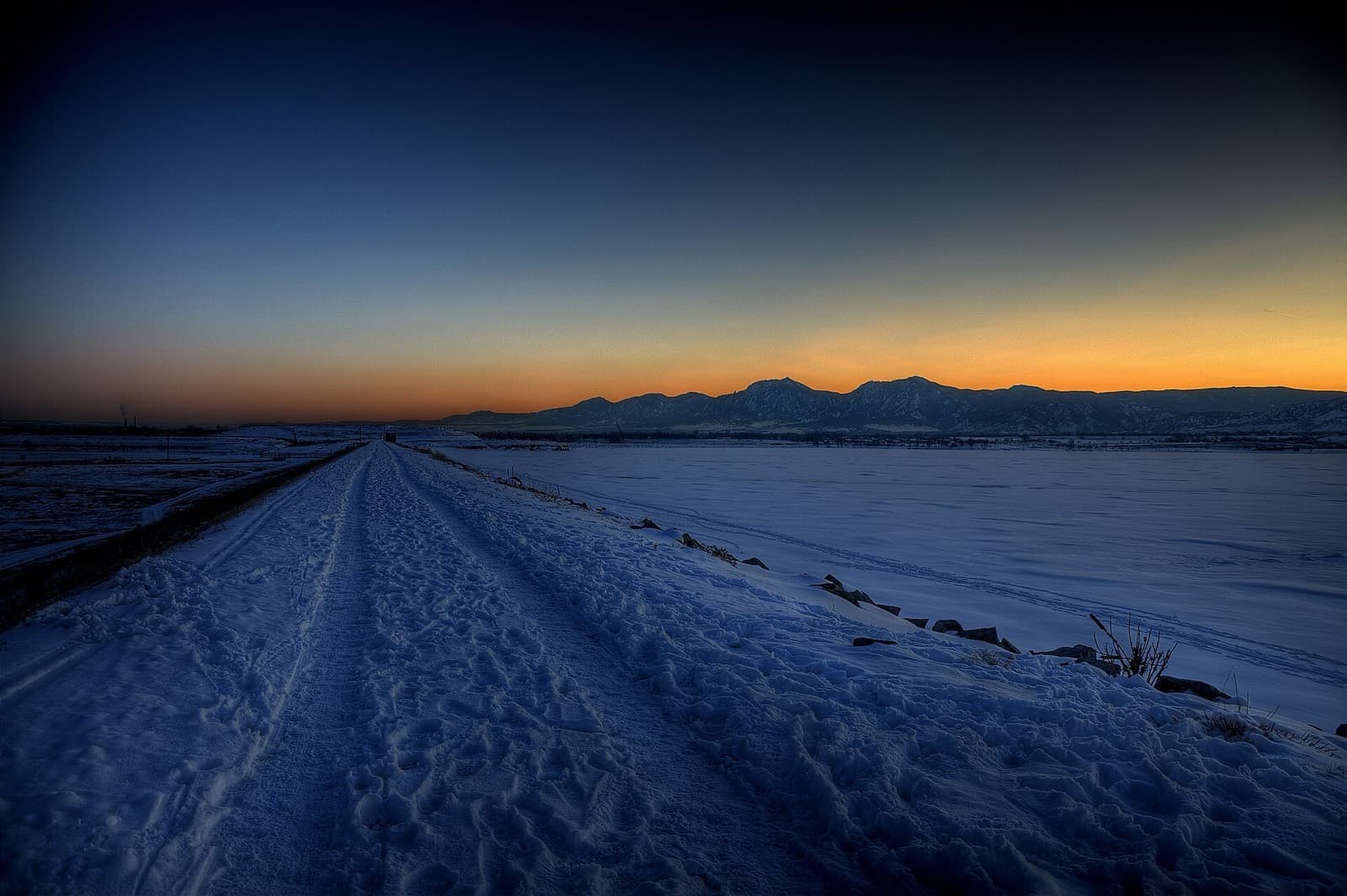 Colorado Triathlon: boulder reservoir at dusk with the flatirons beyond, in winter snow
