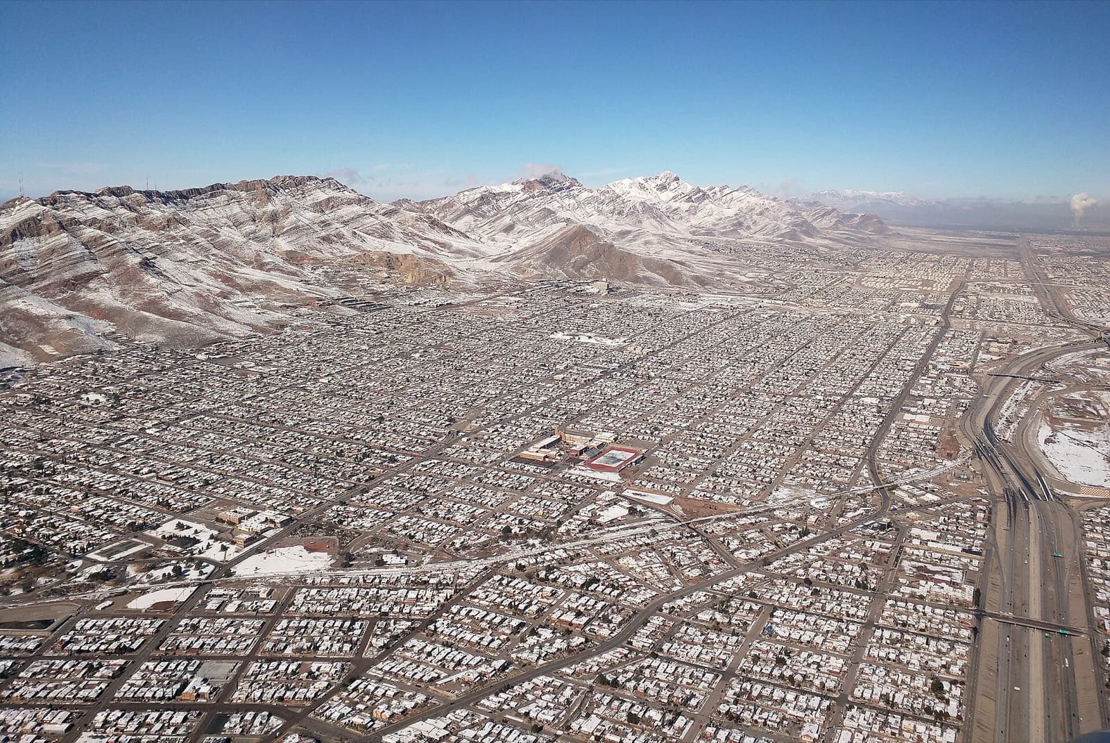 Mighty Mujer Triathlon (El Paso): aerial view of central el paso neighbourhoods below the franklin mountains (winter snow)