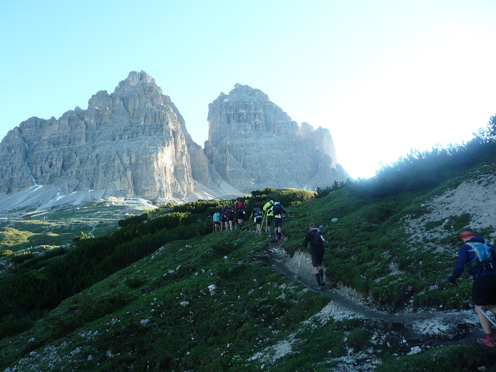 Lavaredo Ultra Trail 120K (La Sportiva Lavaredo Ultra Trail by UTMB): runners climbing toward rifugio auronzo with the tre cime di lavaredo ahead