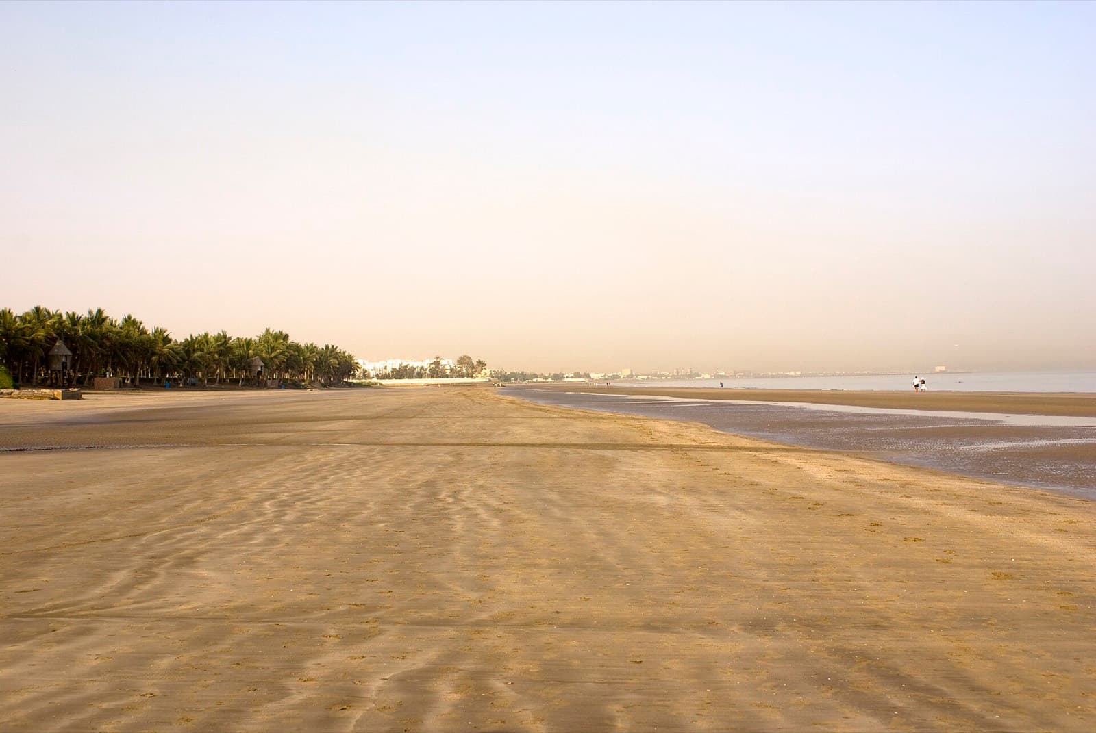 IRONMAN 70.3 Muscat: qurum beach swim venue, wide sandy beach with palms and waterfront