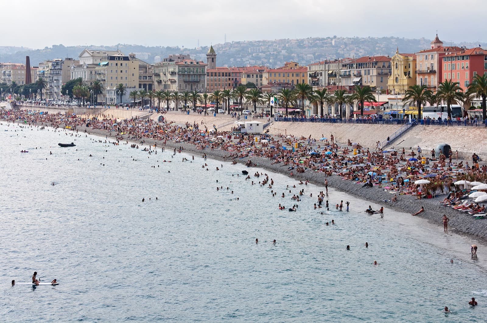 IRONMAN 70.3 Nice: pebble beach and bathers on the baie des anges along the promenade des anglais, nice (swim venue)