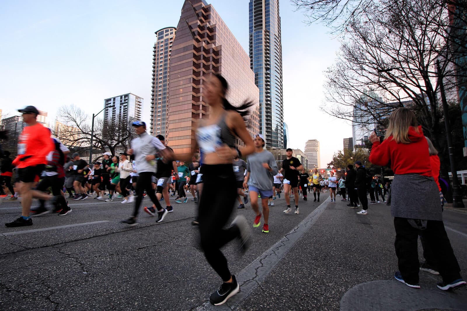 Austin Marathon & Half Marathon: runners on congress avenue after the start of the 2023 austin marathon and half marathon, austin, texas