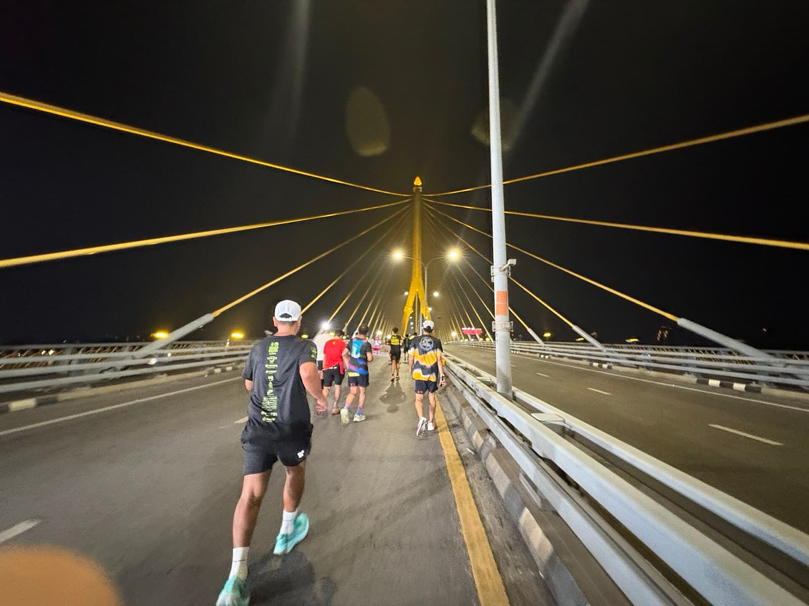 Amazing Thailand Marathon Bangkok: runners crossing the rama viii bridge at night, amazing thailand marathon bangkok 2025