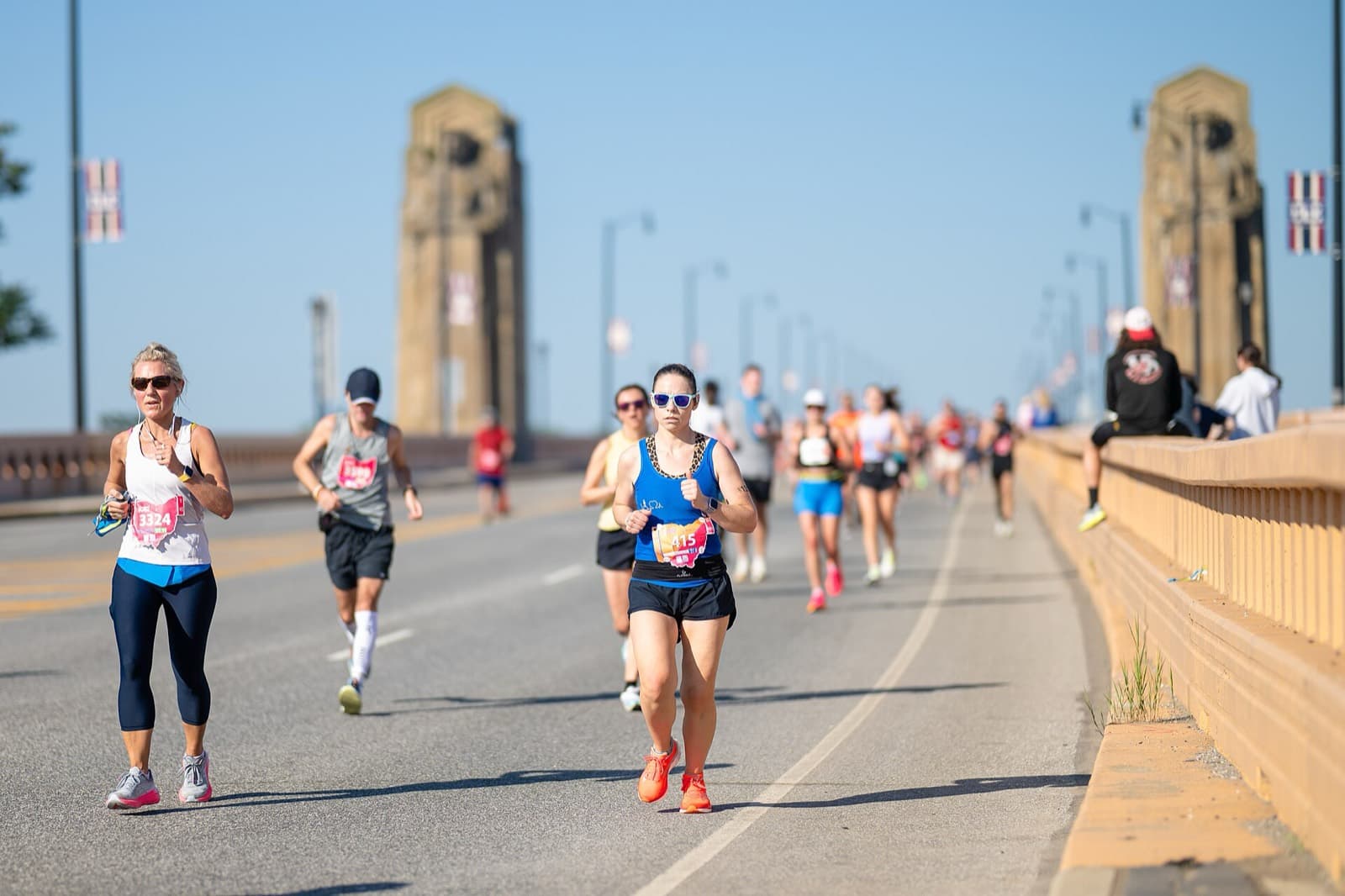 Cleveland Marathon: runners crossing the hope memorial bridge past the guardians of traffic, 2024 cleveland marathon