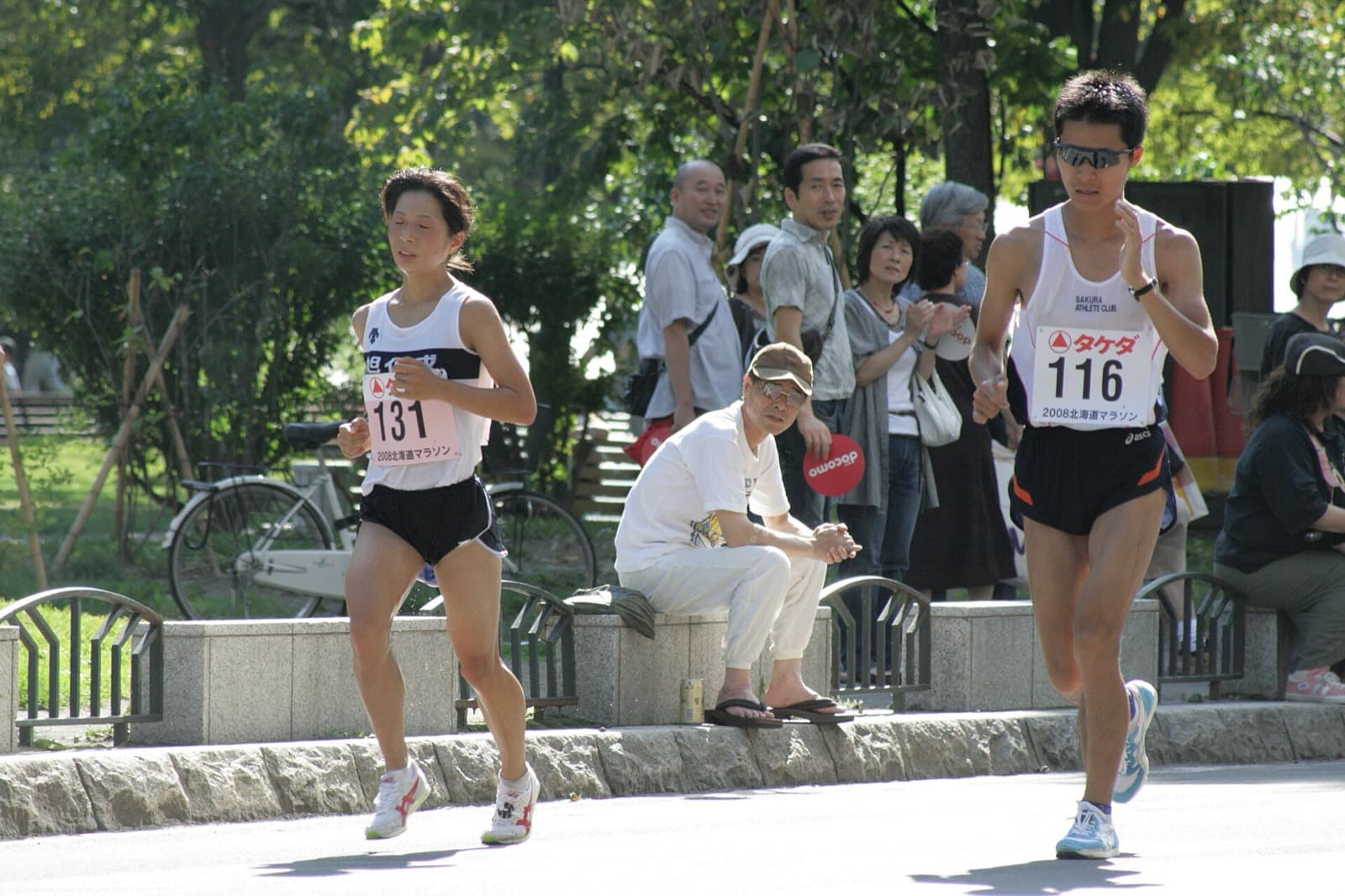 Hokkaido Marathon: runners passing spectators in odori park during the 2008 hokkaido marathon