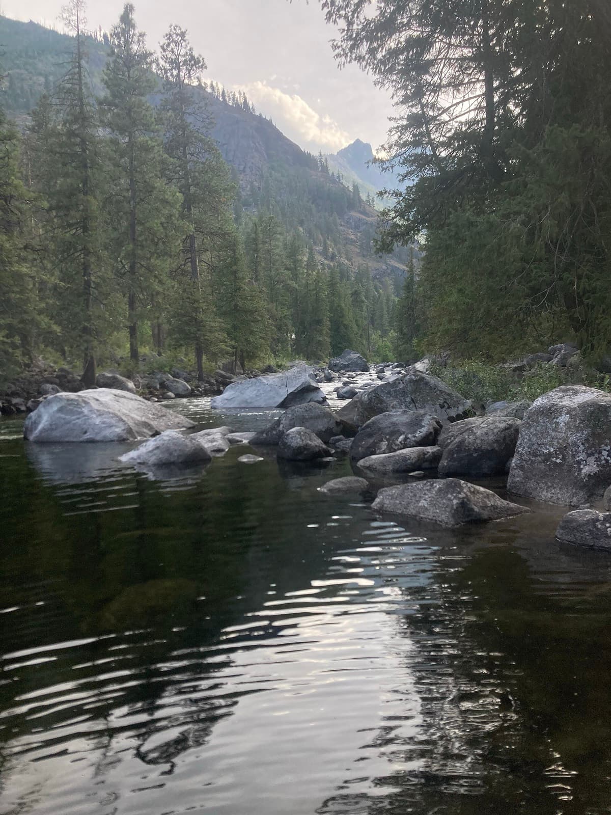 Leavenworth Marathon: icicle creek and boulders with forested mountain behind, near the marathon's canyon section