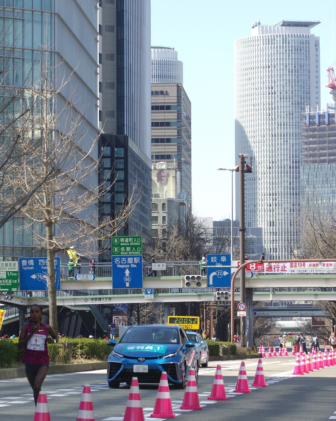 Nagoya Women's Marathon: leader in the 2015 nagoya women's marathon on a city street with jr central towers behind