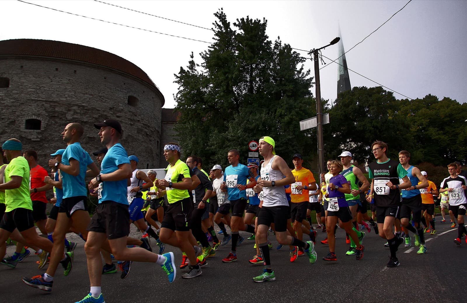 Swedbank Tallinn Marathon: marathon runners passing the fat margaret tower in tallinn old town, 2016