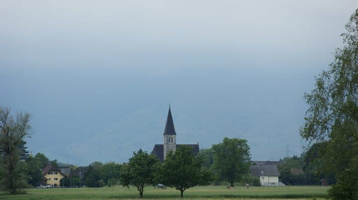 Ruggell parish church across the Rhine valley meadows
