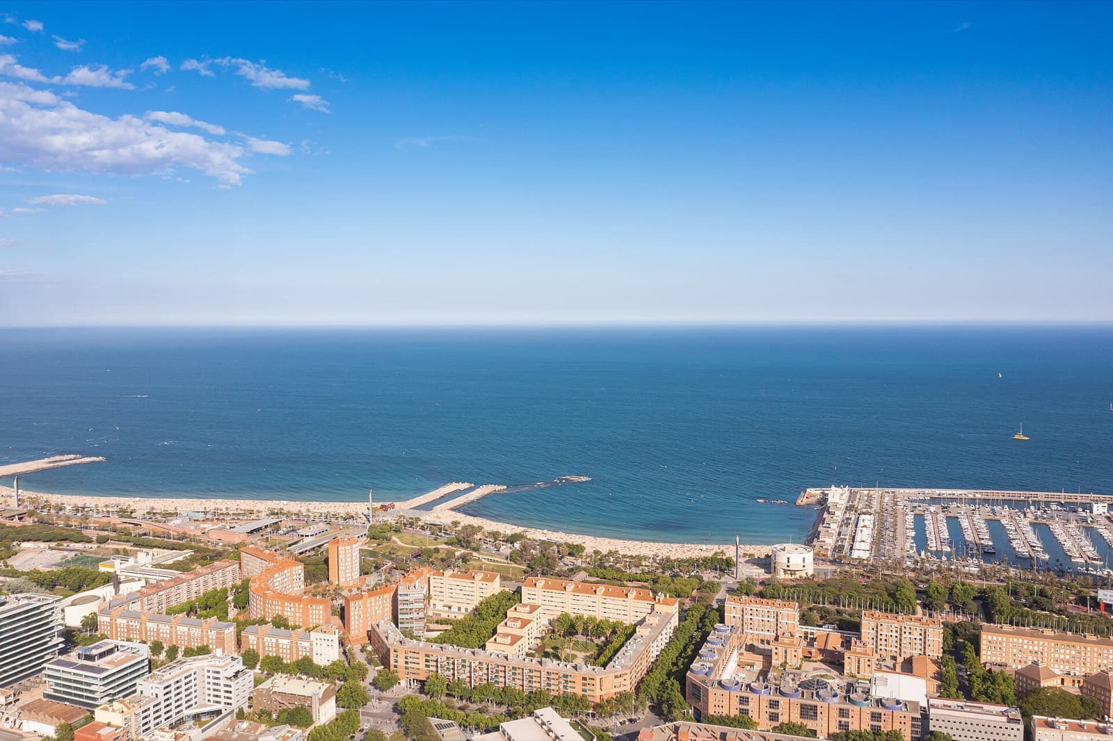 Barcelona Triathlon (Challenge Barcelona Triathlon): aerial view of nova icaria beach, breakwaters and port olimpic next to mar bella