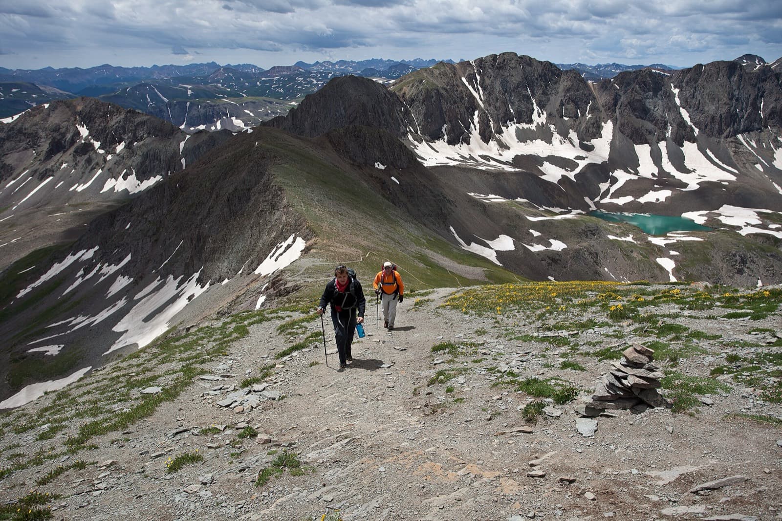 Hardrock 100 Endurance Run: hikers climbing a ridge trail near handies peak in the san juans